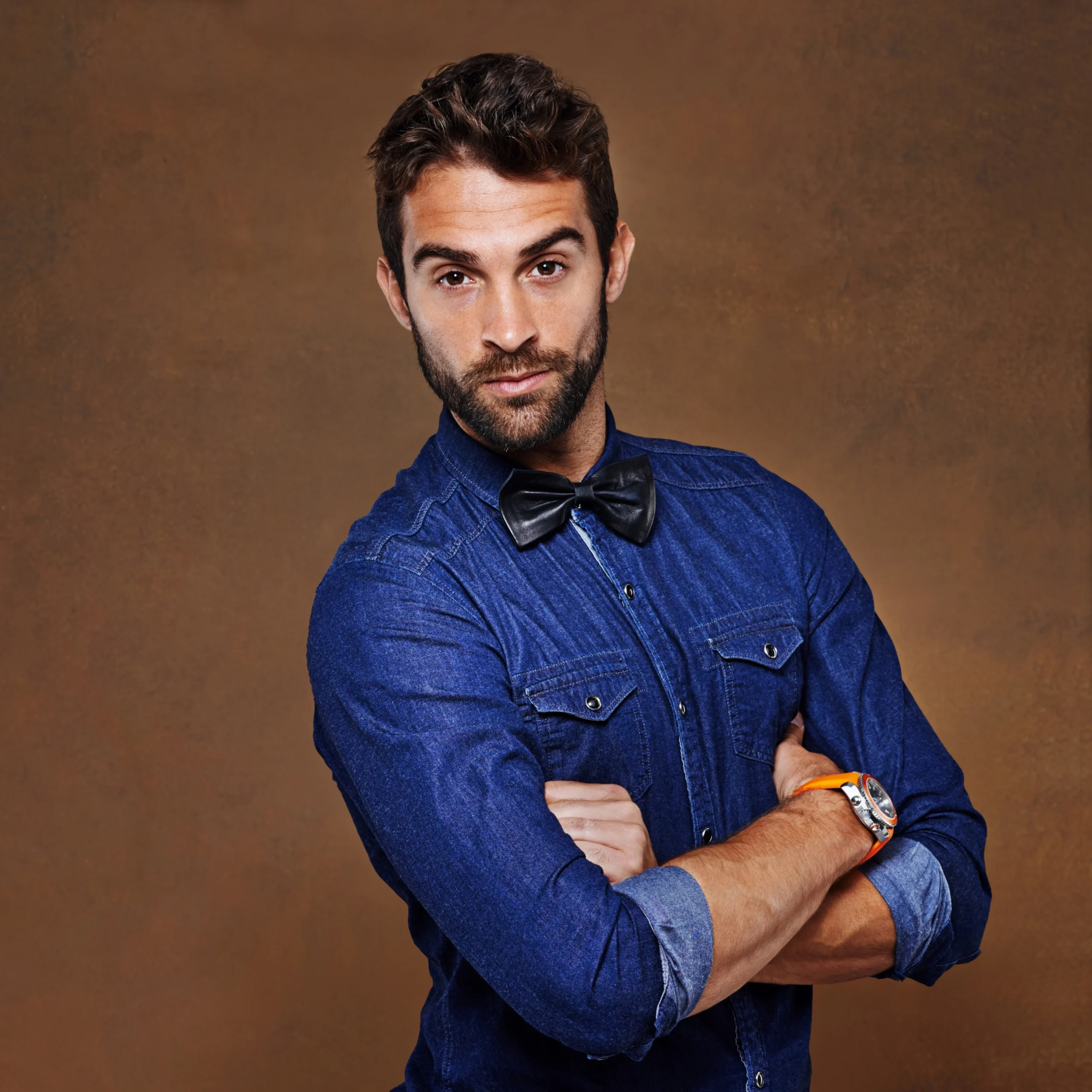 Our creative director posing with crossed arms, responsible for developing unique visual identities and high-converting brand strategies for models at the onlyfans agency.